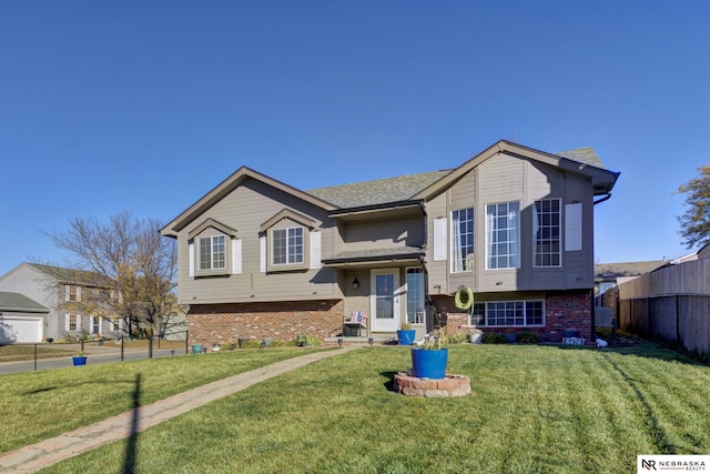 bi-level home featuring a front yard and a garage