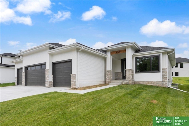 prairie-style home featuring a front lawn and a garage