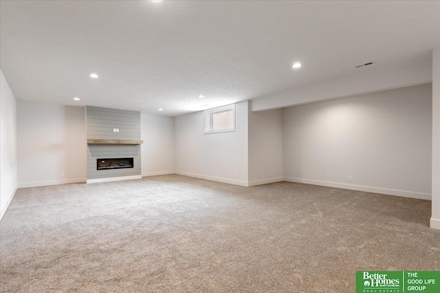 unfurnished living room with a fireplace and light colored carpet