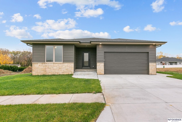 view of front of property featuring a front lawn and a garage