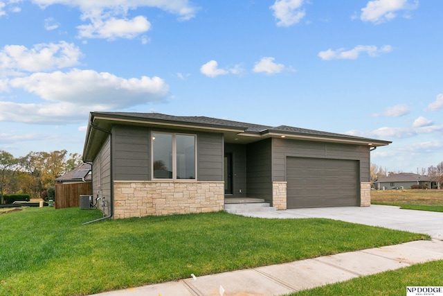 view of front facade featuring central air condition unit, a garage, and a front lawn