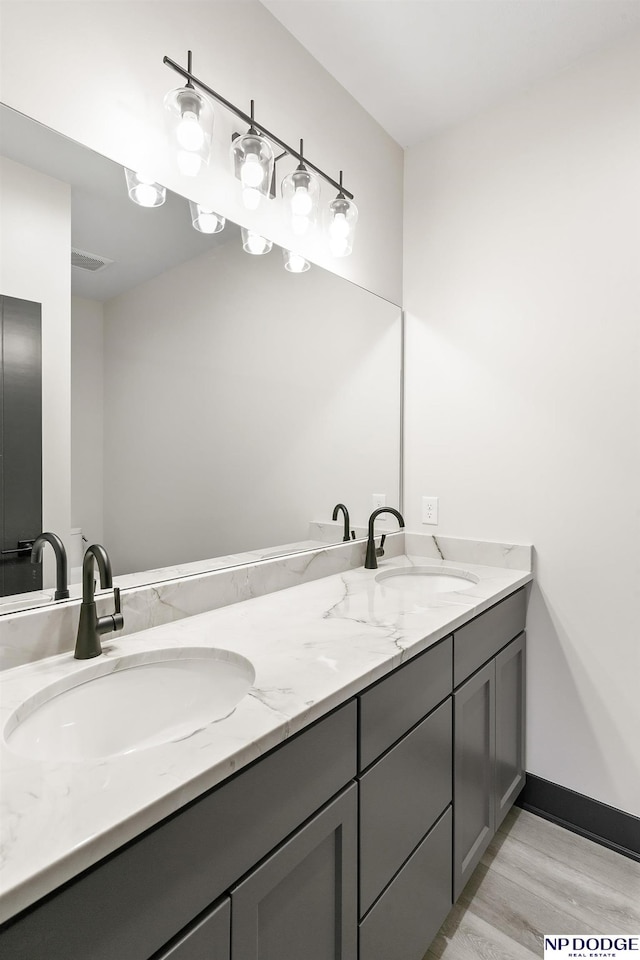 bathroom with hardwood / wood-style floors and vanity