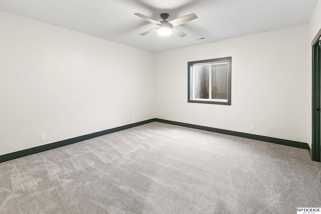 carpeted spare room featuring ceiling fan