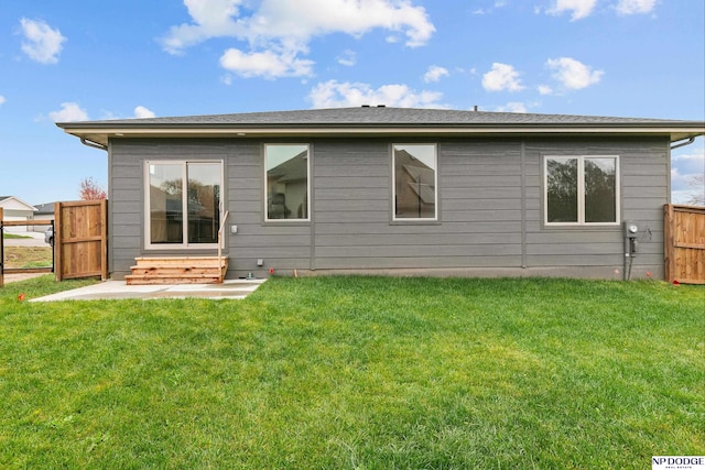 rear view of house with a yard