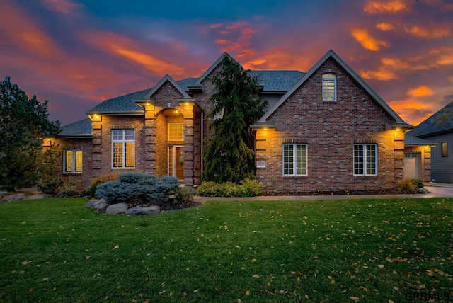 view of front of house with a garage and a lawn