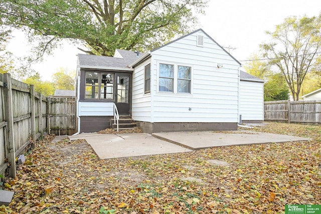 back of house with a sunroom and a patio area