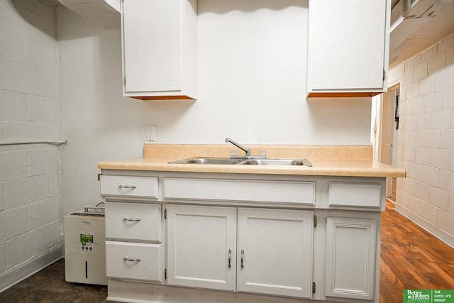 kitchen with white cabinetry, dark wood-type flooring, and sink