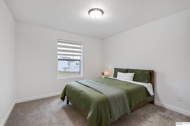 carpeted bedroom with a textured ceiling