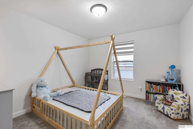 bedroom with carpet and a textured ceiling