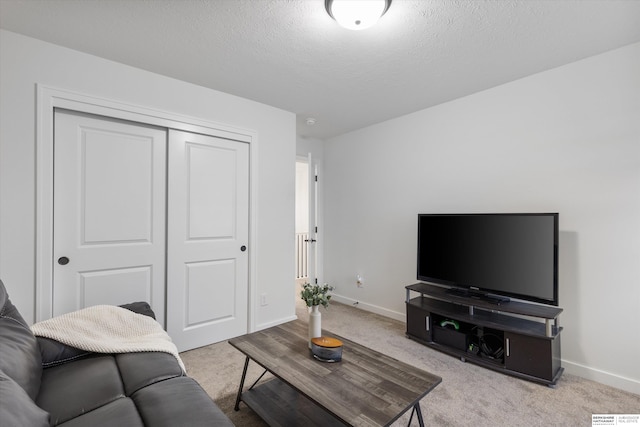 carpeted living room with a textured ceiling