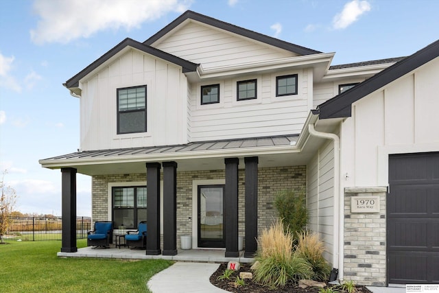 view of front of house with covered porch and a front yard