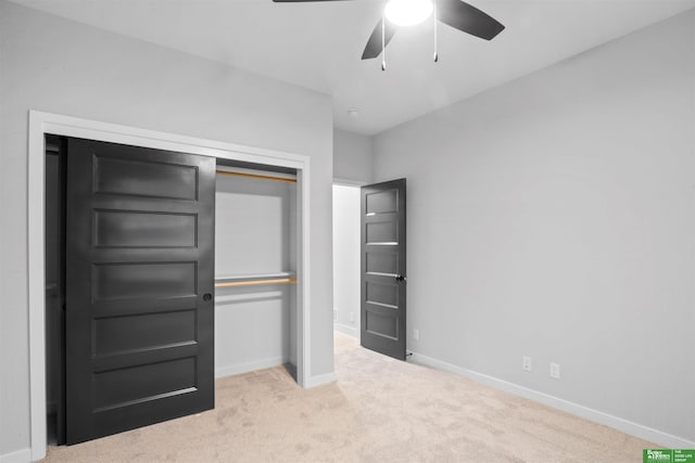 unfurnished bedroom with ceiling fan, a closet, and light colored carpet