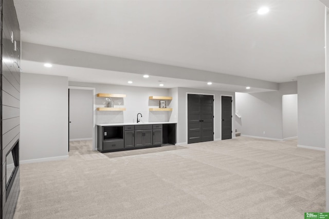 basement with wet bar and light carpet