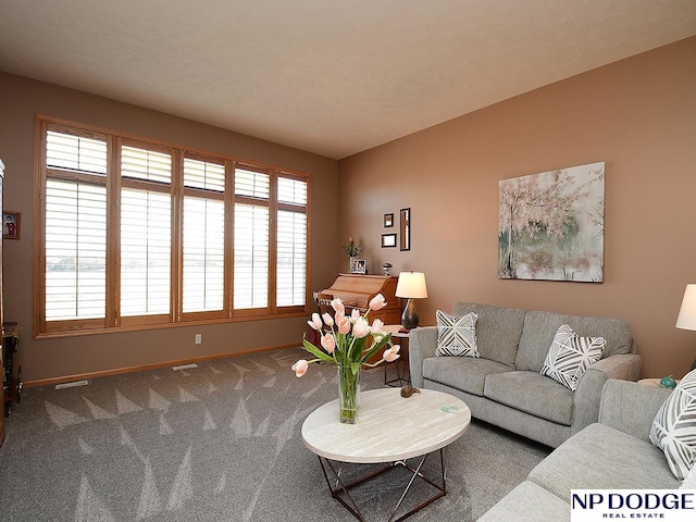 living room featuring carpet and plenty of natural light