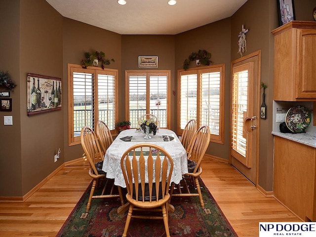 dining space with light hardwood / wood-style flooring