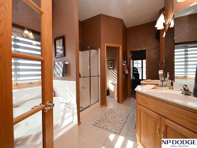 bathroom featuring tile patterned flooring, vanity, and separate shower and tub