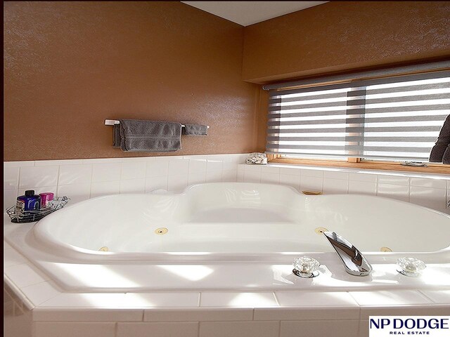 bathroom featuring tiled bath