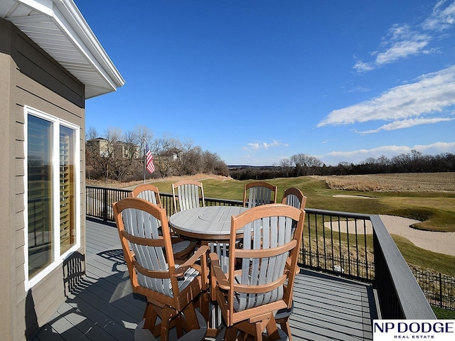 wooden terrace featuring a yard