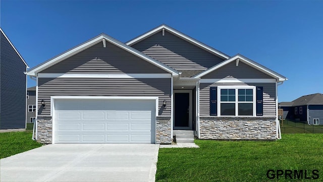 13521 Whitmore St, Omaha, NE 68142 - view of front of home with stone siding, driveway, a front yard, and an attached garage