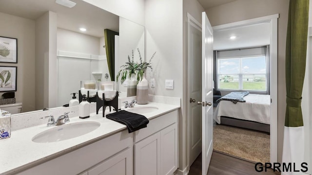 bathroom featuring toilet, vanity, and hardwood / wood-style flooring