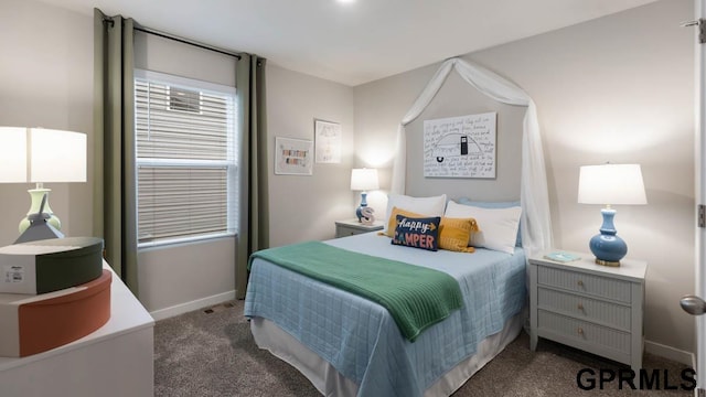 bedroom with dark colored carpet