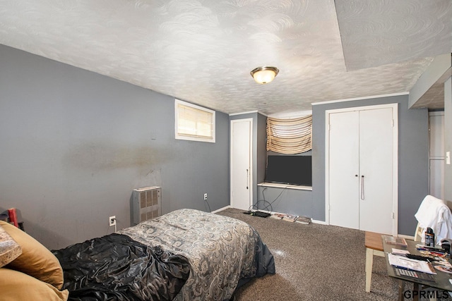 bedroom with a closet, a textured ceiling, and carpet floors