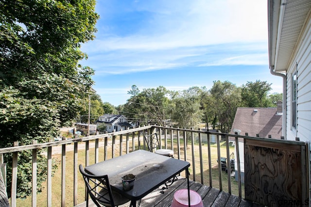 wooden terrace with a lawn