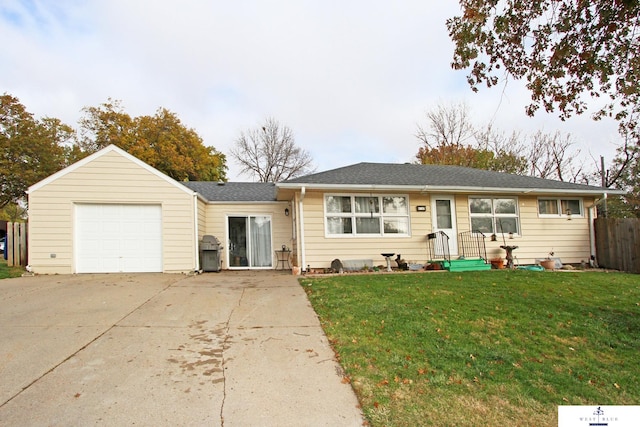 ranch-style house featuring a garage and a front lawn