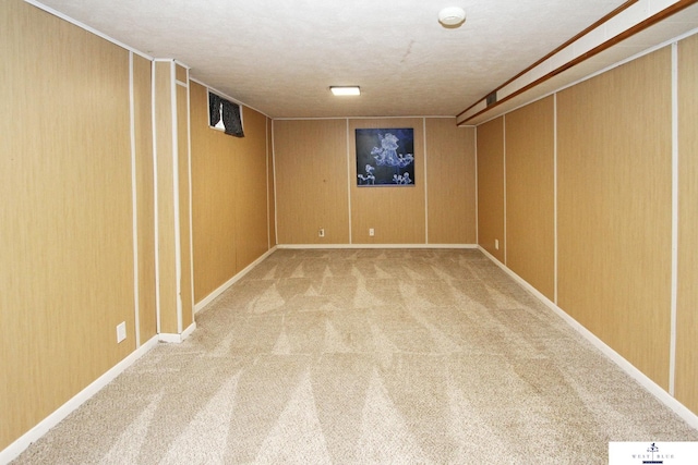 basement with wooden walls and carpet flooring