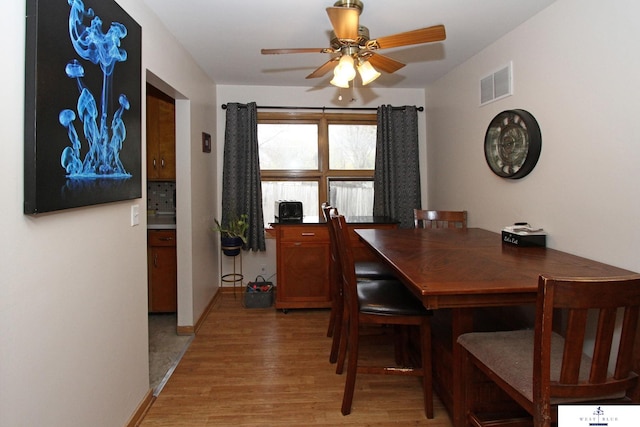 dining area featuring hardwood / wood-style flooring and ceiling fan