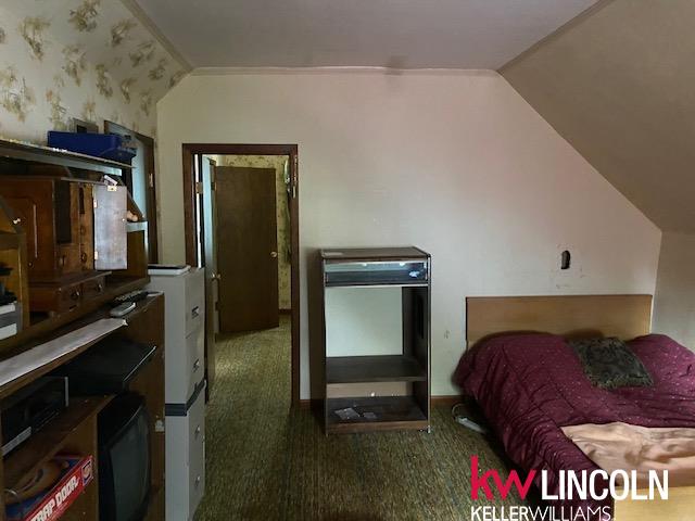 carpeted bedroom featuring lofted ceiling