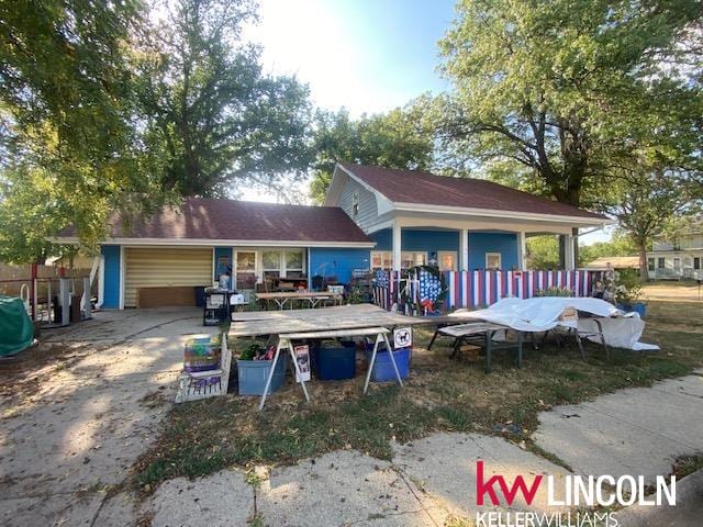 rear view of property featuring a garage