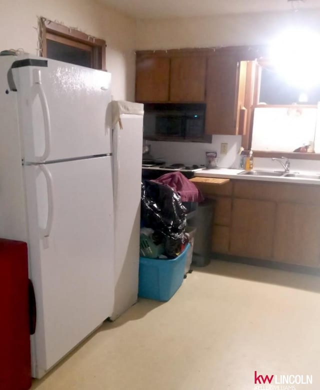 kitchen with white refrigerator and sink