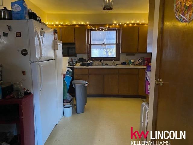 kitchen with sink and white refrigerator