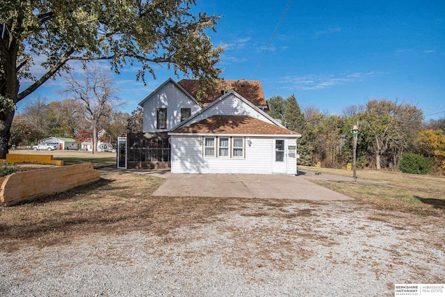 view of home's exterior with a yard and a patio