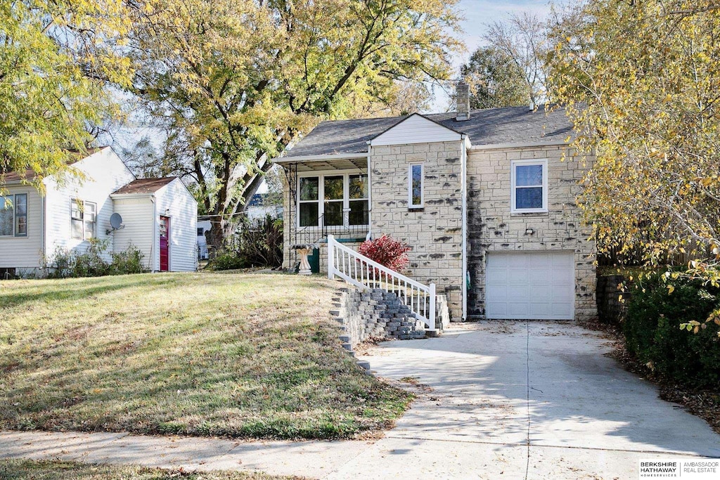 view of front of home with a garage and a front yard