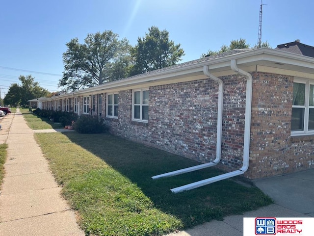 view of side of home with a lawn