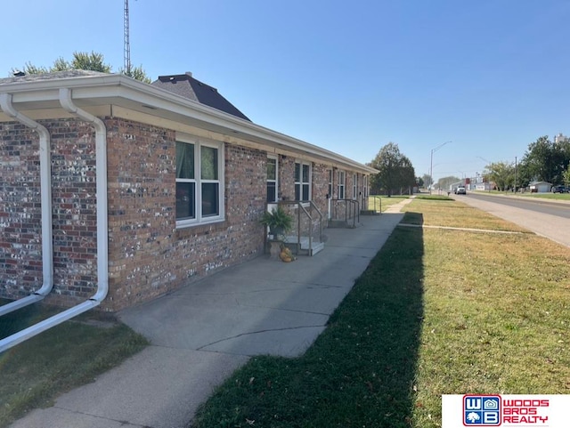 view of side of home featuring a lawn