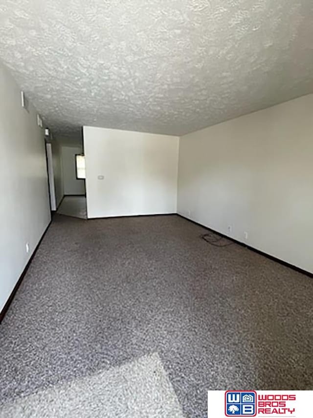 unfurnished room featuring a textured ceiling