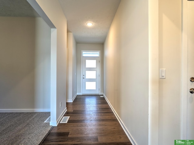 entryway featuring a textured ceiling and dark hardwood / wood-style floors