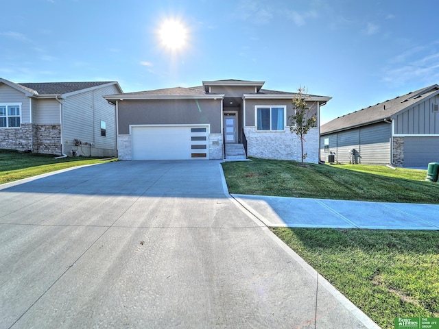 view of front facade with a front yard and a garage