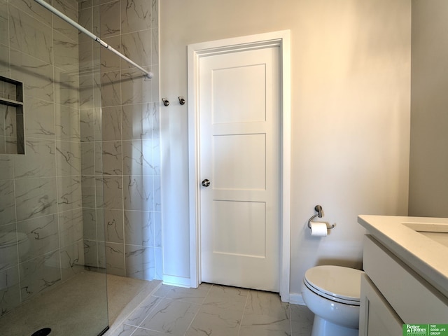 bathroom featuring toilet, vanity, and a tile shower