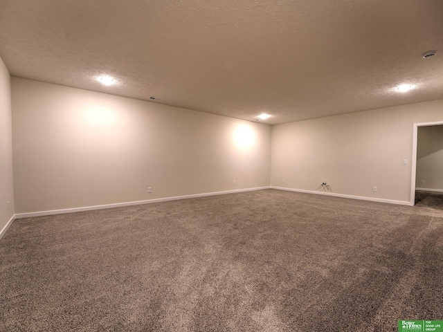 carpeted empty room featuring a textured ceiling