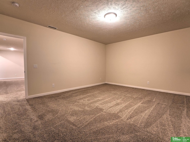 unfurnished room featuring carpet floors and a textured ceiling