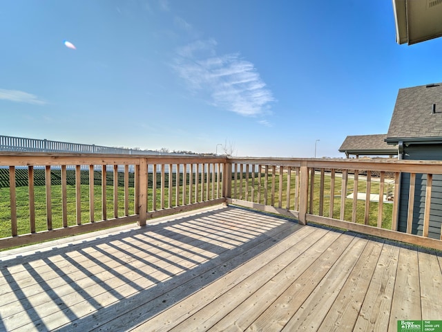 wooden terrace featuring a yard