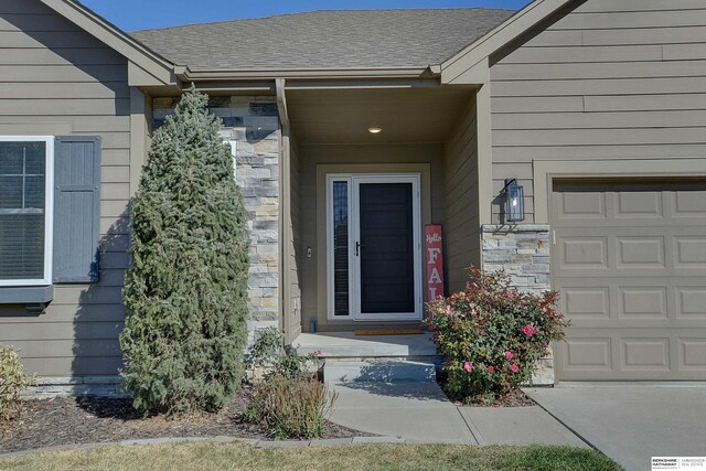 doorway to property with a garage