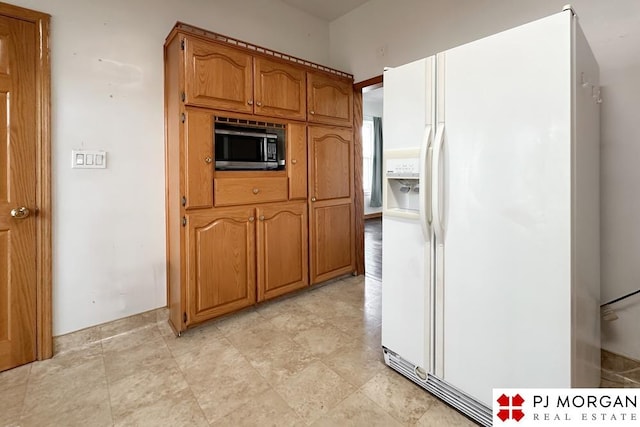 kitchen with white fridge with ice dispenser