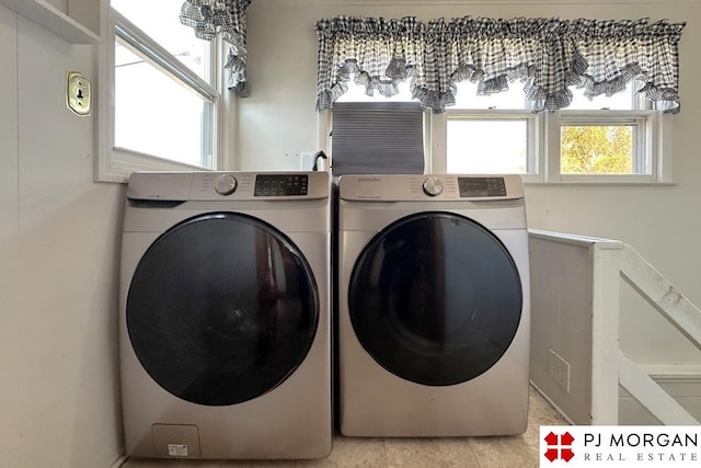 washroom featuring light tile patterned floors and washer and clothes dryer