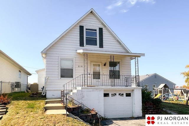 bungalow with a garage, central AC unit, and a porch