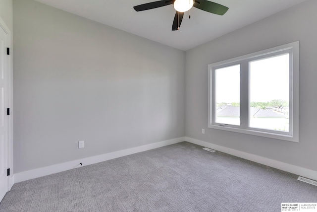 carpeted empty room featuring ceiling fan